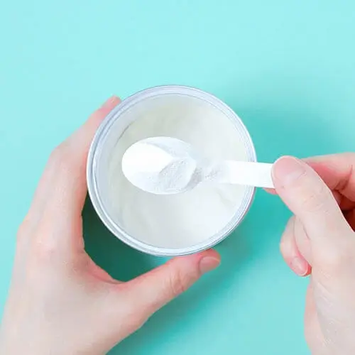 powdered collagen in a messy scoop